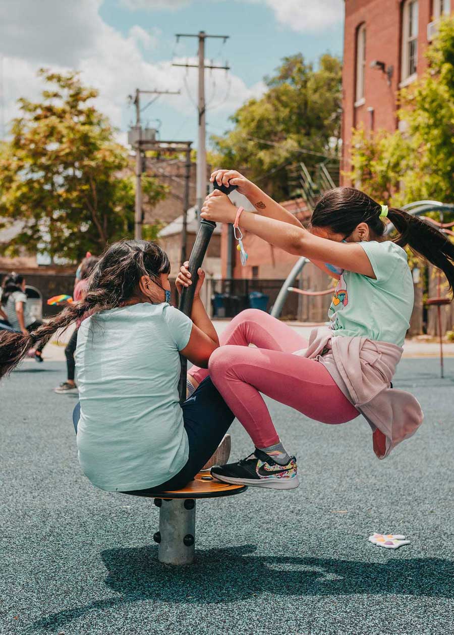 2 Perez girl students spinning on playground