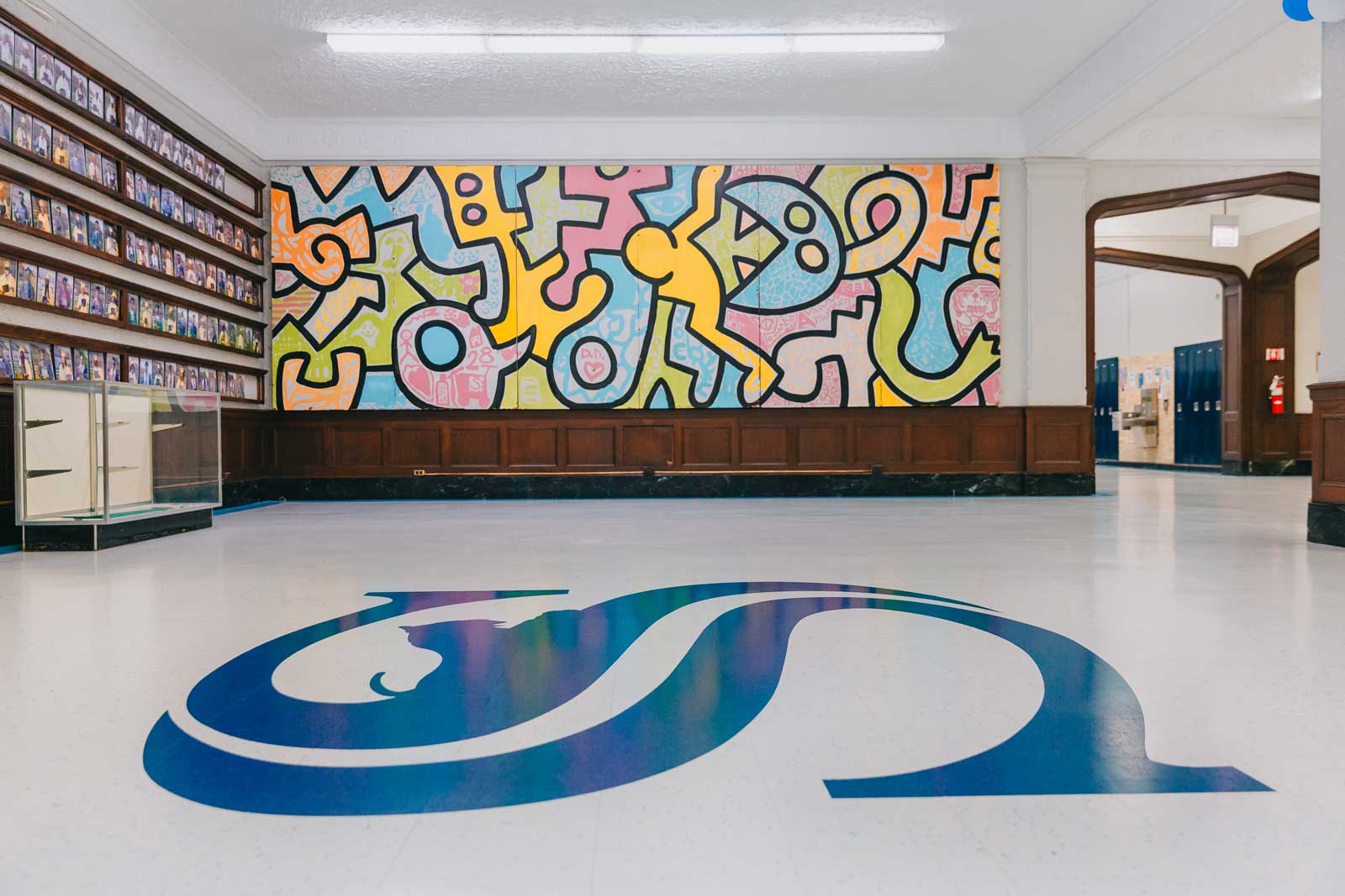 blue sullivan logo on ground with art in background